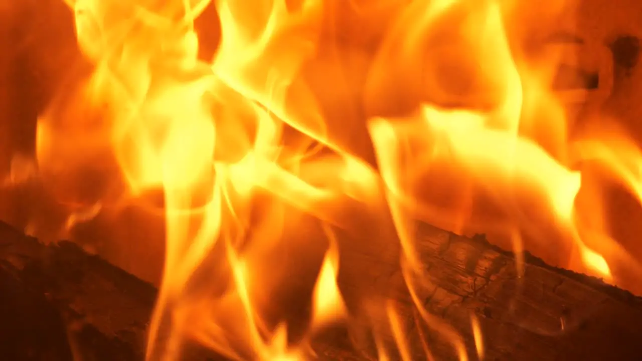 Slow motion of burning fire in cozy fireplace Close-up shot