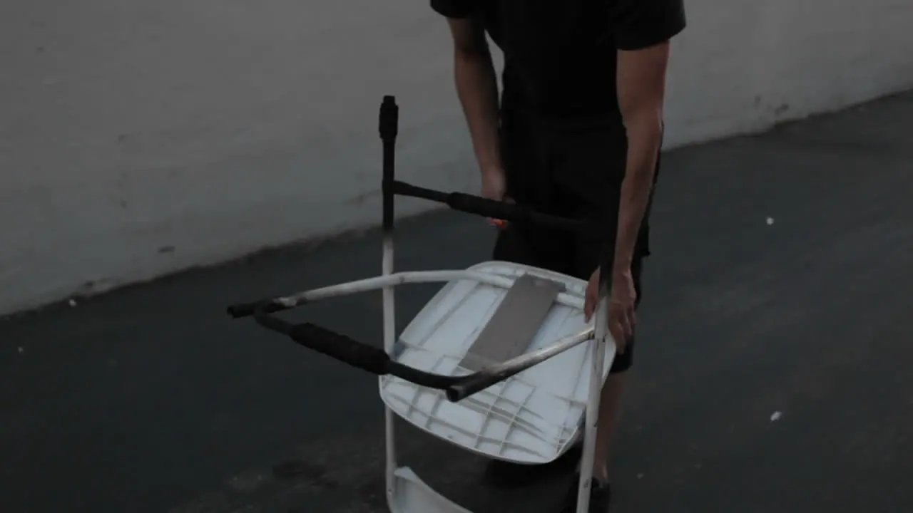 A street performer demonstrates his ability to juggle flaming torches whilst balancing a flaming chair on his forehead