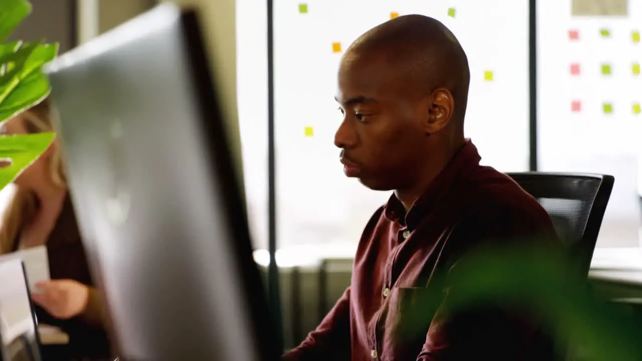 Male executive working on computer at desk 4k