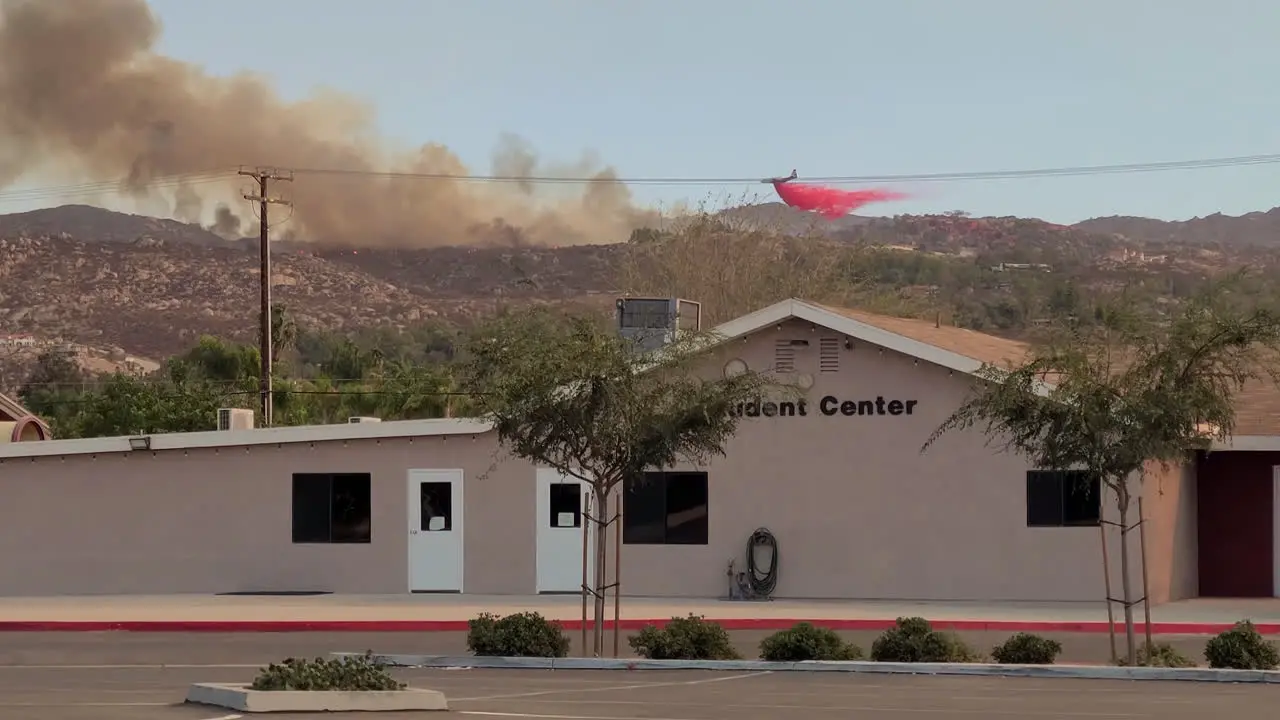 Airplane trying to extinguish a fire on a hill