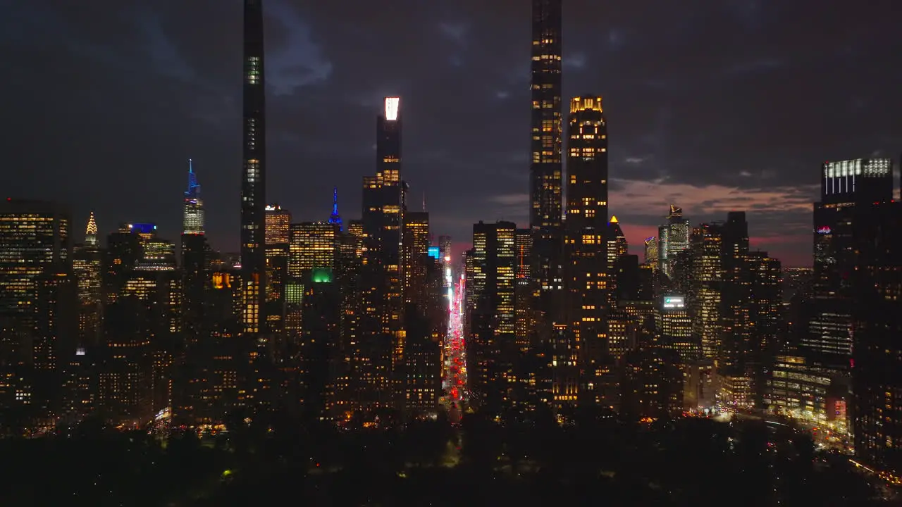 Metropolis downtown at night Illuminated high rise buildings skyscrapers and streets Night life in city Manhattan New York City USA