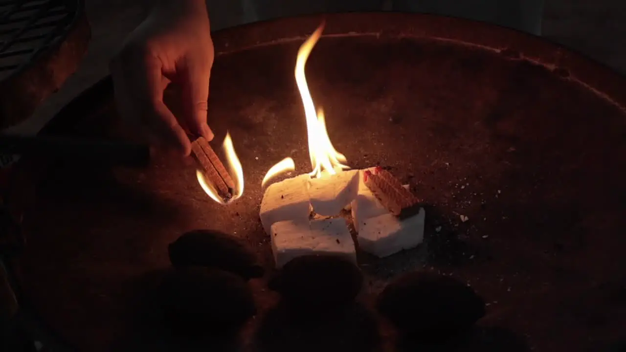 Close up of person lighting a flame on a grill at a campsite