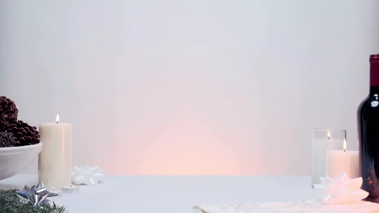 White background with candles and wine bottle