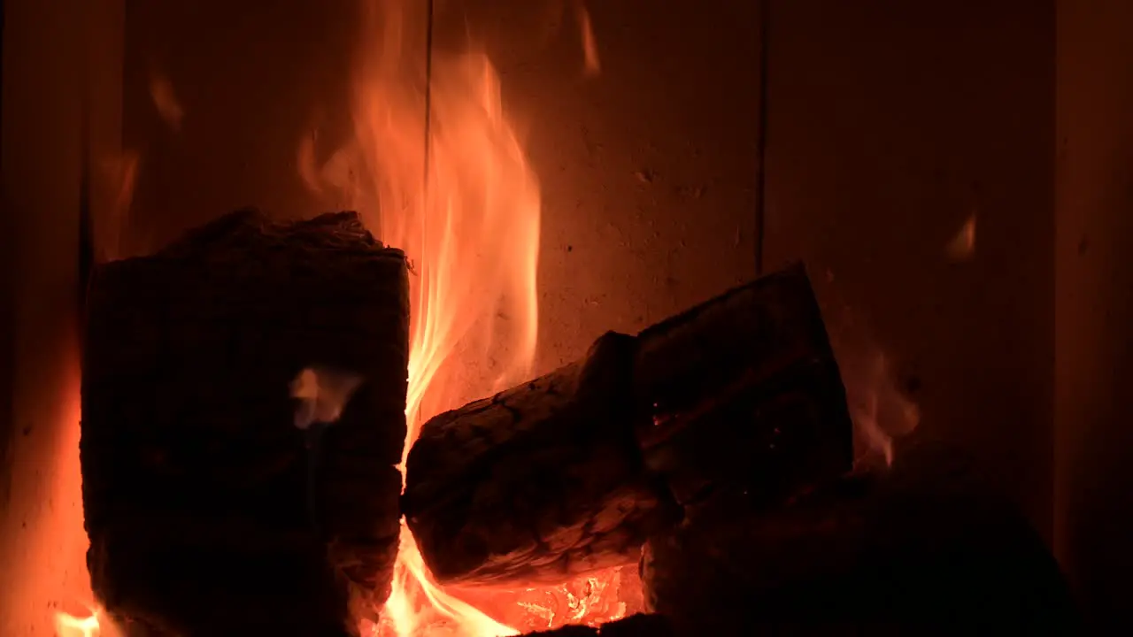 fire flame burning wood in fireplace at home during cold winter season