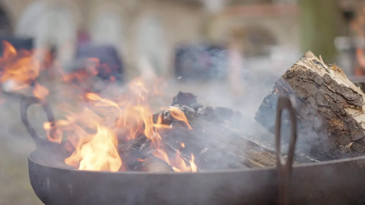 flickering flames and smoke of burning bonfire in a bowl slow motion