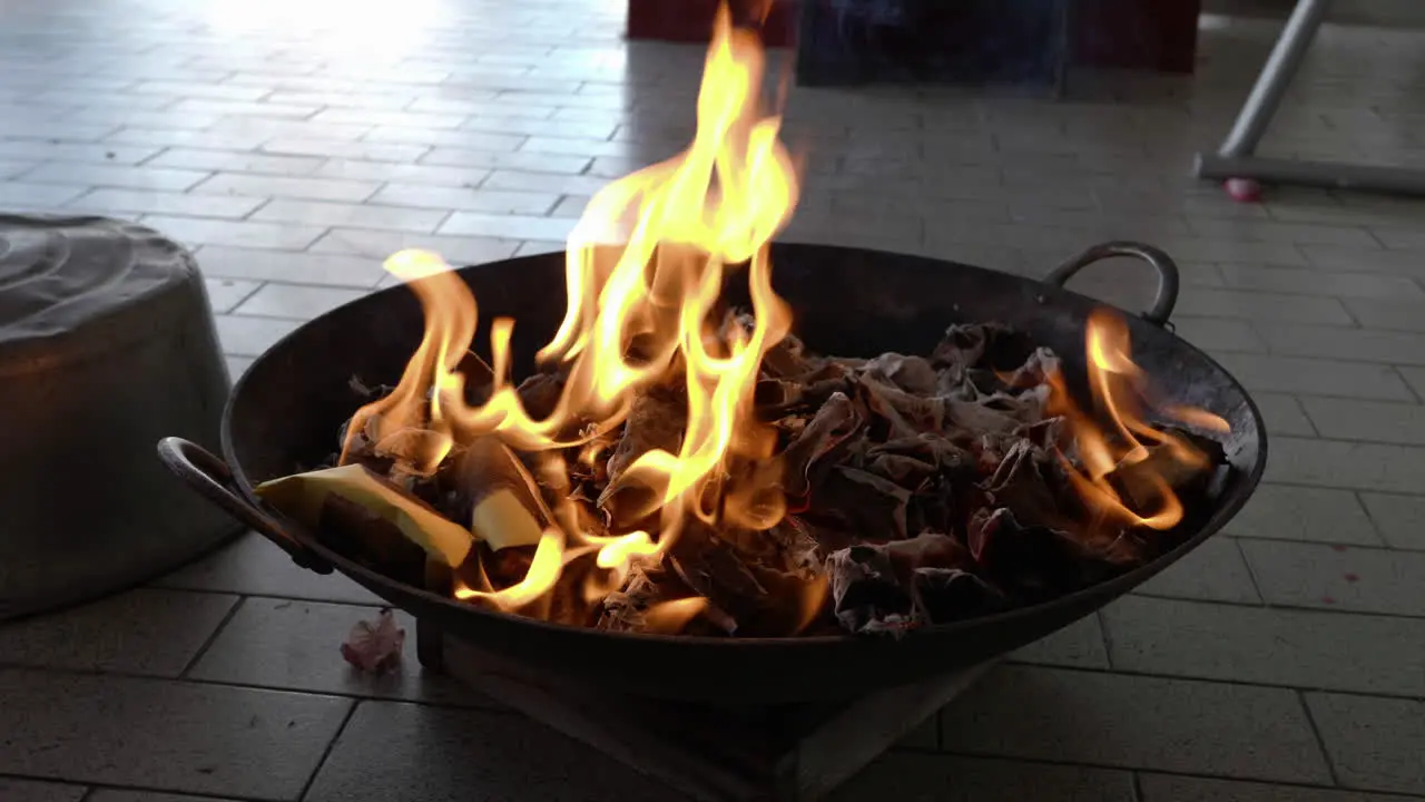 Close-up burning joss paper pray to the ancestor