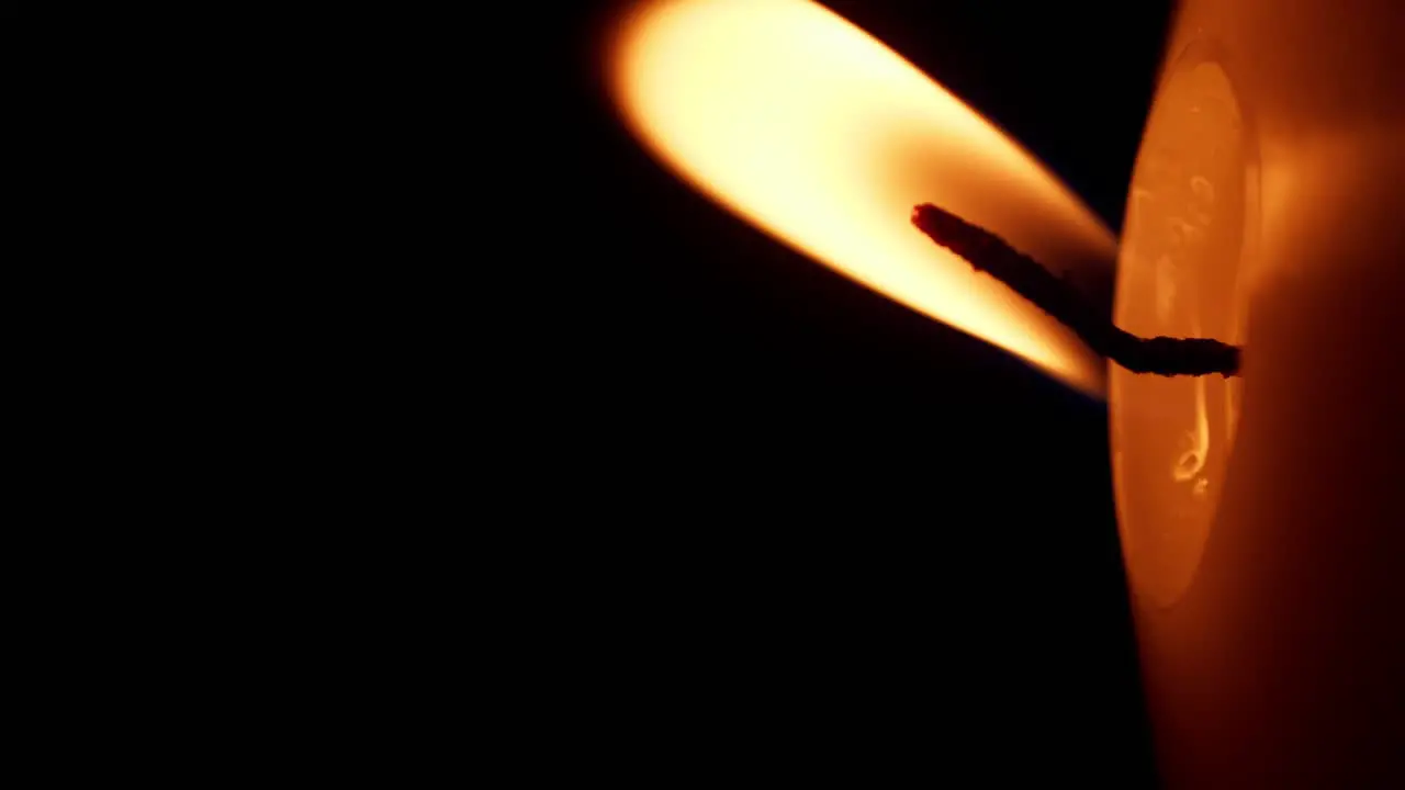 Vertical rotation of Closeup of candle flame on black