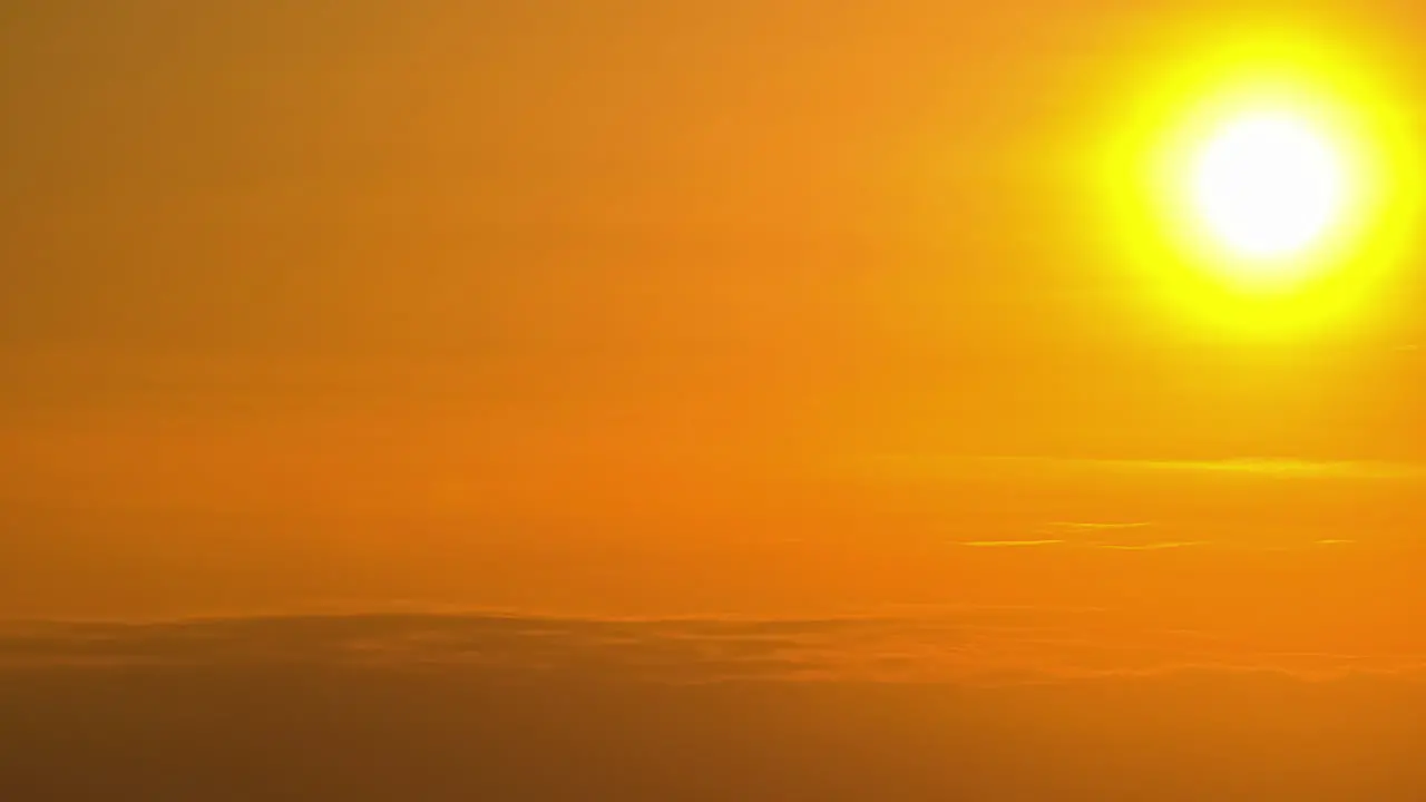 Timelapse of dramatic sun in the sky rising on the cloud with no land visible