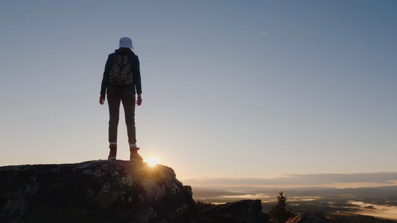 Woman Traveler Waving A Cap At The Top Of The Mountain Success And Active Holidays In Norway