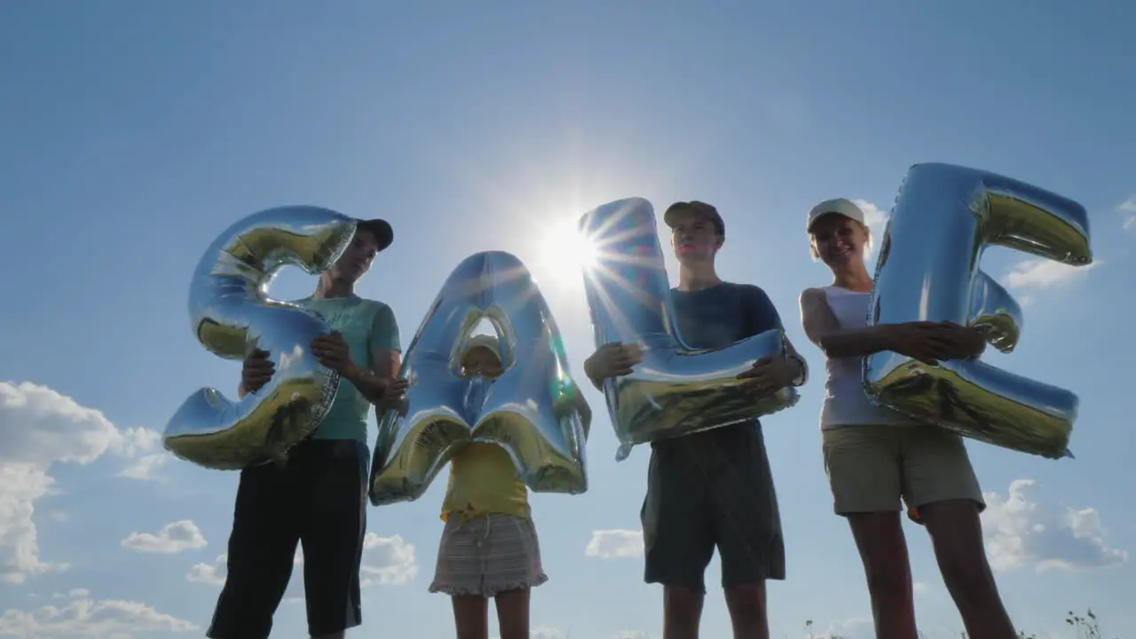 Several People Hold Balloons With The Word Sale 4K Video