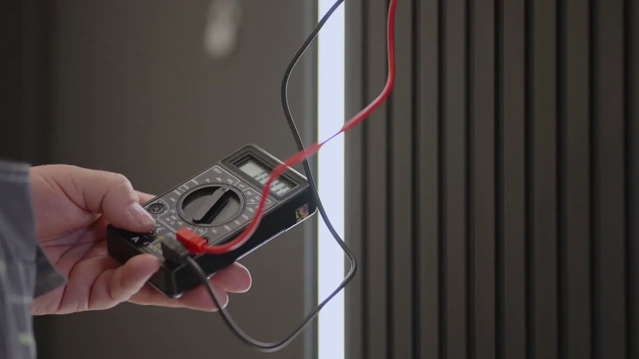 Close-up electrician checks the voltage with a special device Electrician tester to check current