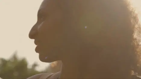 Close Up Shot of Young Woman Backlit Against the Sun