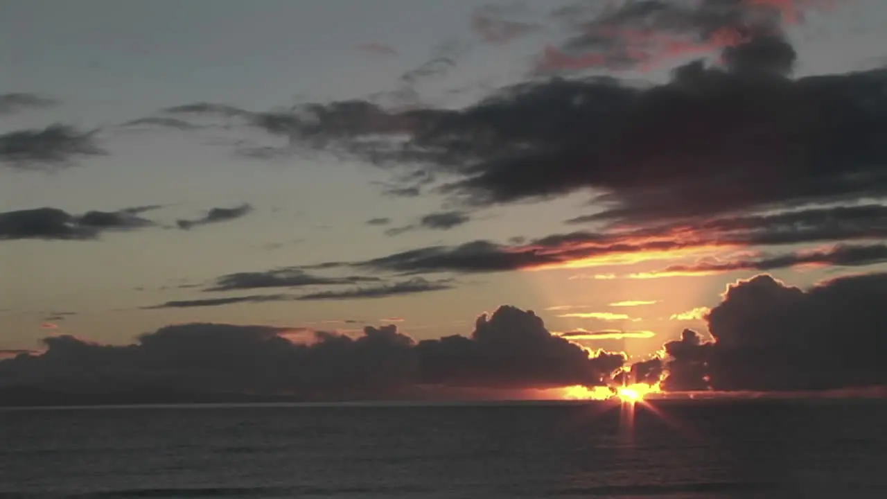 The sun hangs low over the ocean