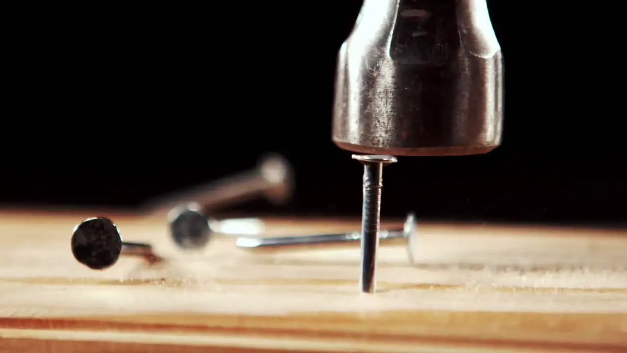 Hammer hammering nail into wood