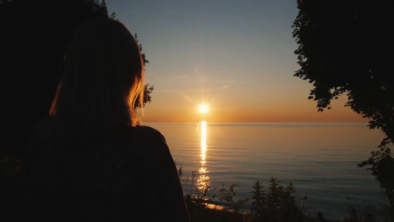 Woman Tourist Admires The Sunset Over The Sea In The Tropics