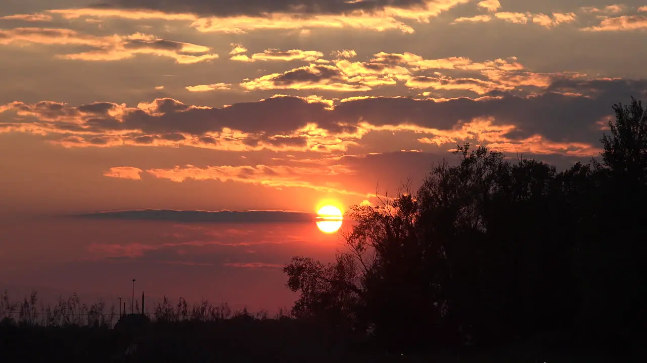 Italy Sun Sinking Below Cloud Wisp