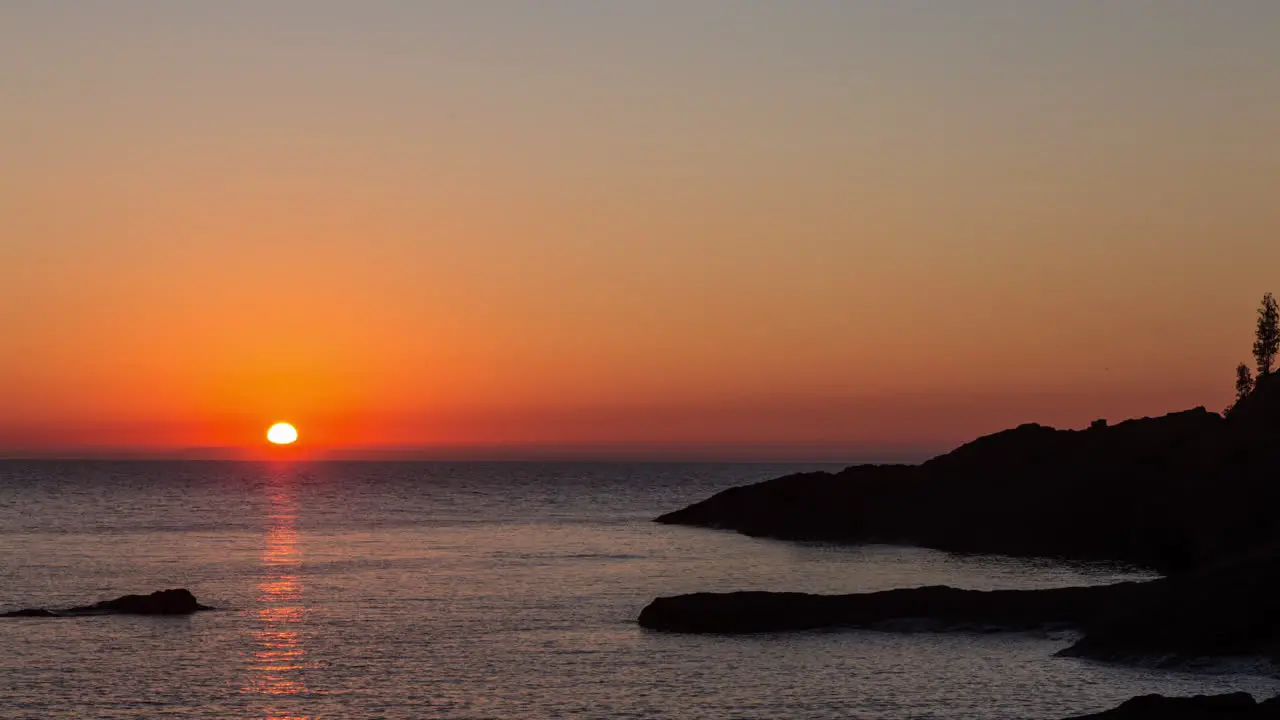 Time-lapse of sunrise above the rocky shore of Lake Superior