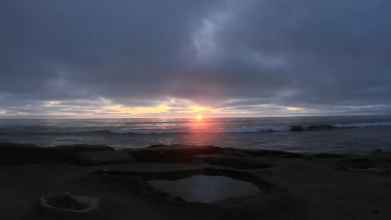 Waves roll on to a beach just after sunset 2