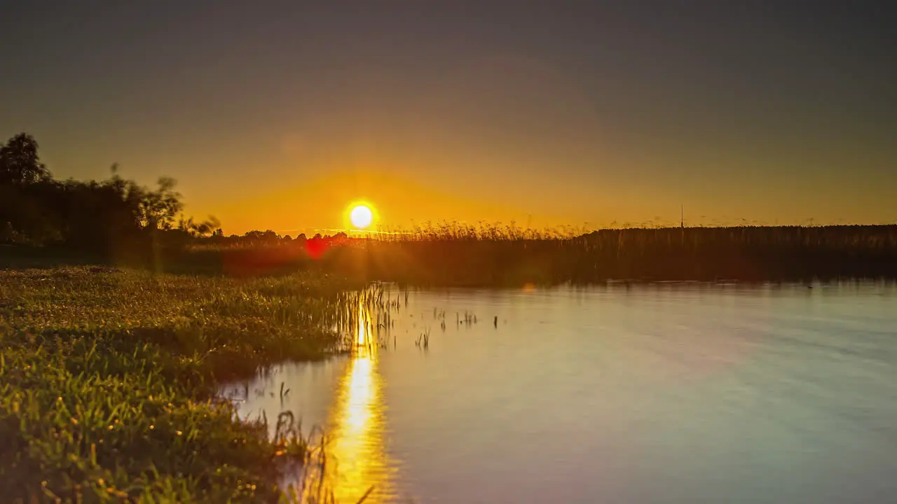 Shot of high tide to low tide with the view of sun setting in the background in timelapse