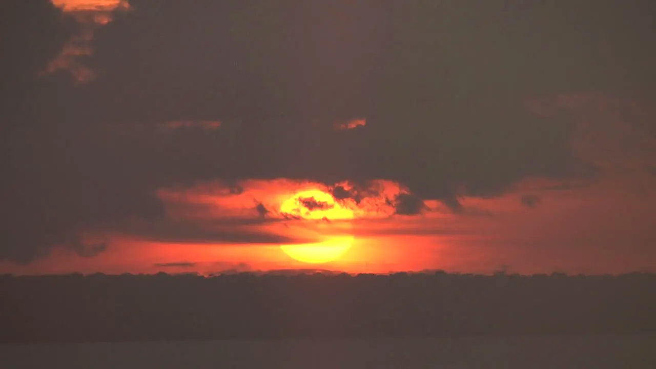 Manaus orange ball of sunset on Rio Negro