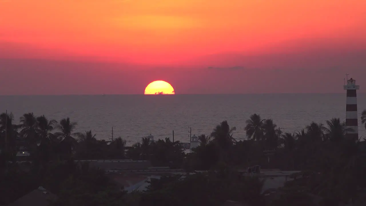 Mexico sinking sun and lighthouse