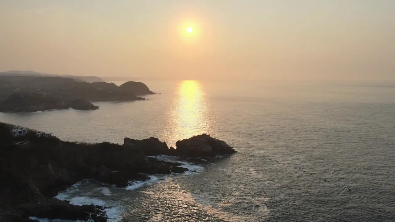 Jib up above sea and rocky shore at sunrise in Oaxaca's coast