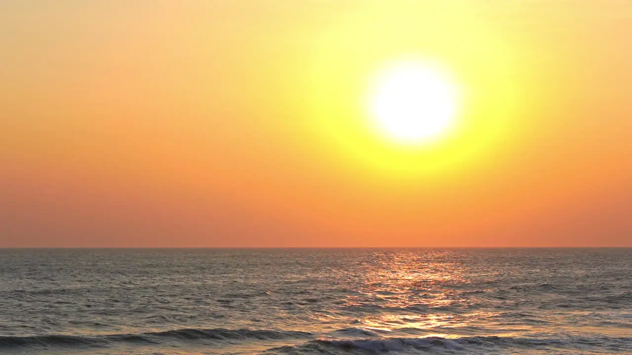 Yellow Sun and Birds Flying Above Tropical Sea