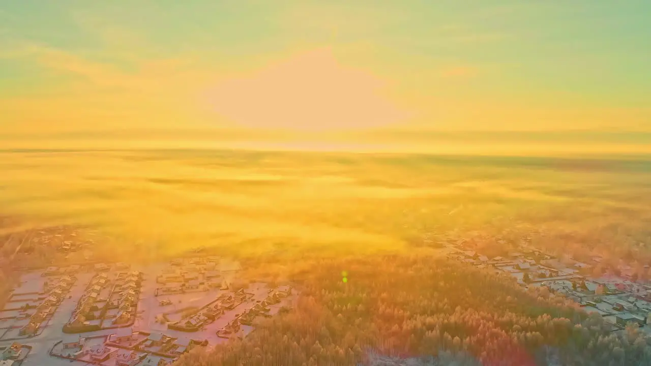 A bright sunrise morning in winter above a suburb in the forest aerial flyover