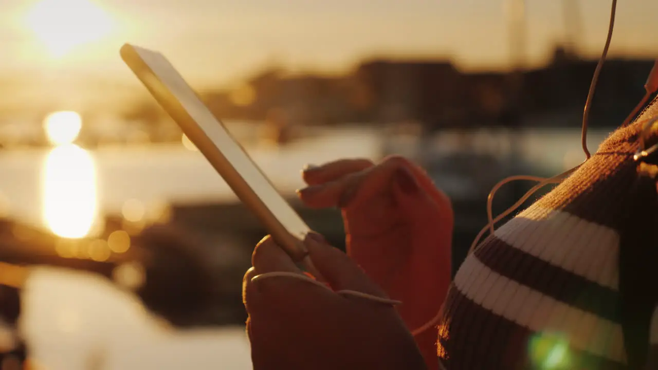 Hands Of A Woman With A Smartphone On The Background Of A Pier With Yachts At Sunset 4k Video