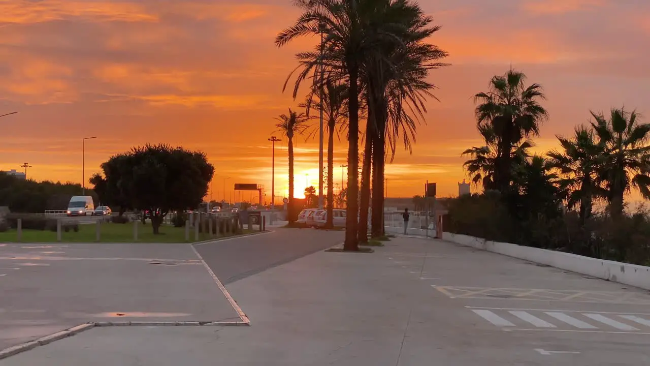 Incredible beautiful sunrise sky reflections over fort Saint Julian at Carcavelos beach near Lisbon amazing orange teal and gray tones man seeing the waves