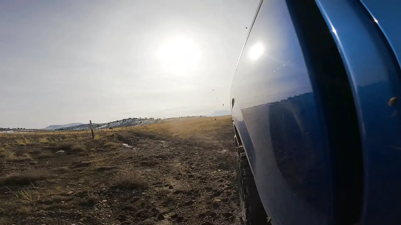 Driving off-road through the dirt and mud in a truck rear view in slow motion