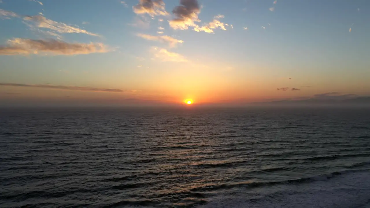 Scenic Sunset Over Sea Waves And Beach aerial drone shot