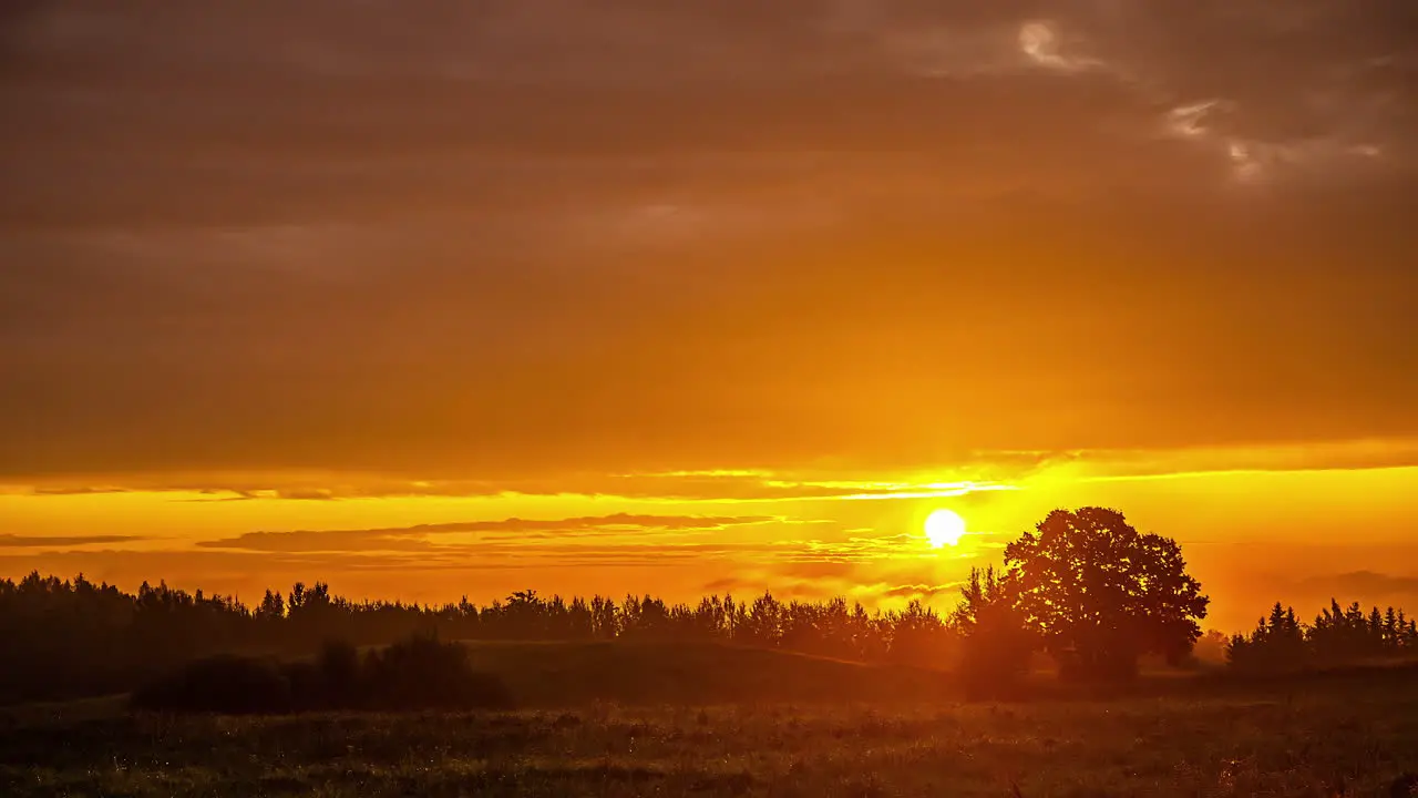 Sunrise on a cloudy day over the countryside Time lapse