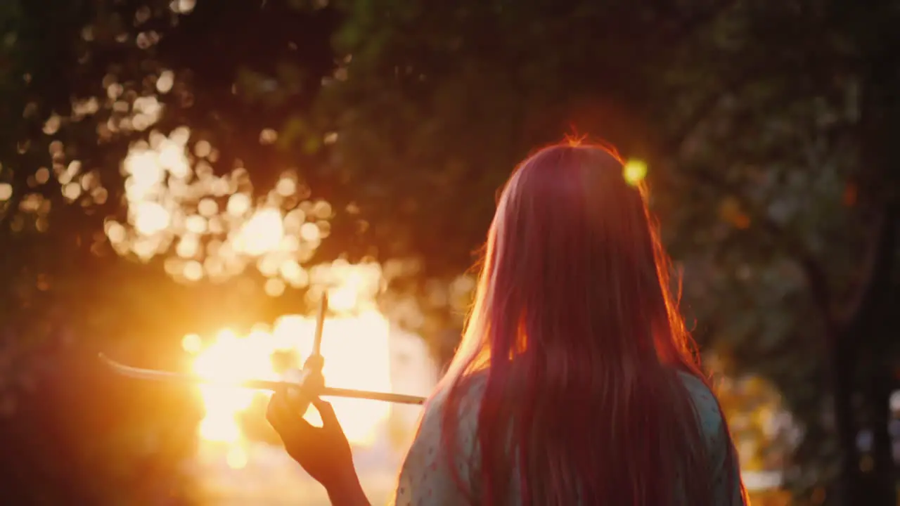 A Child Plays A Plane In The Rays Of The Setting Sun