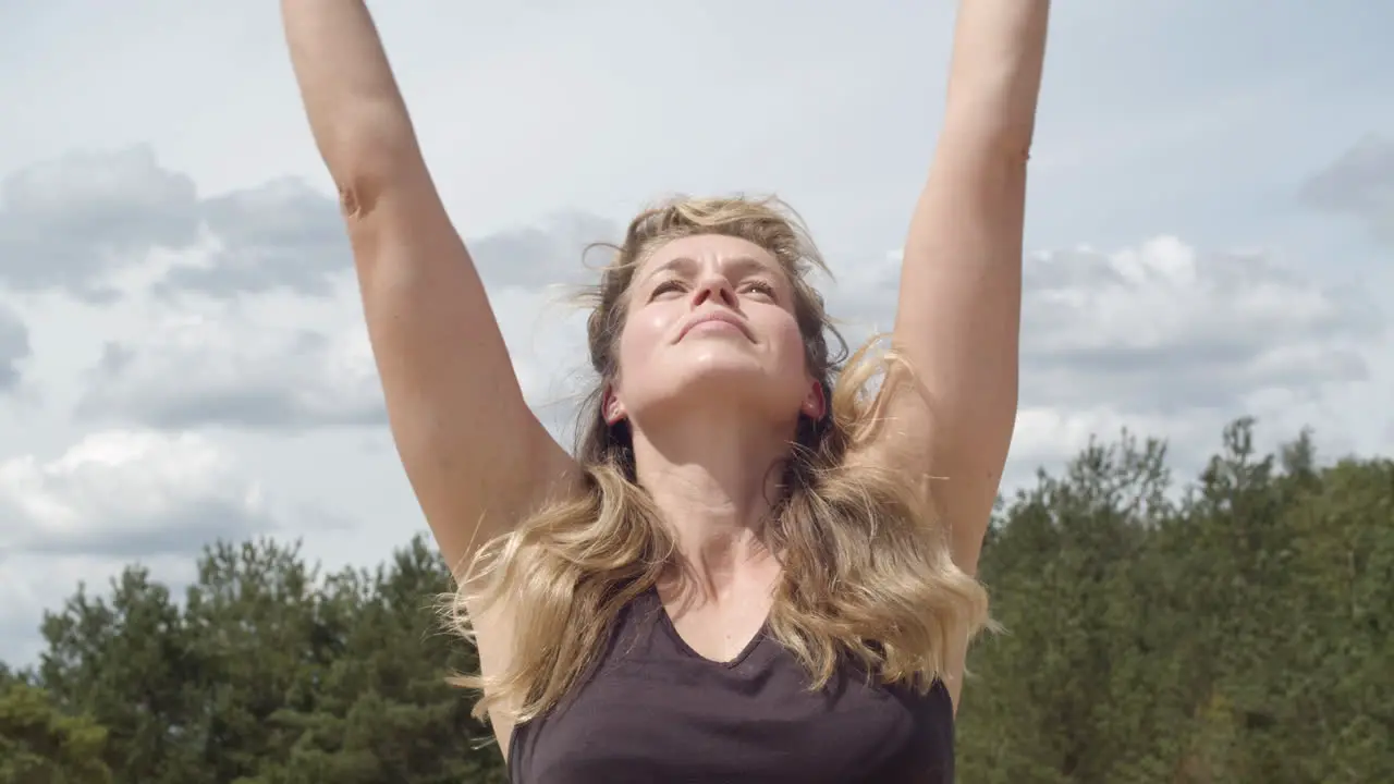 Close up of woman reaching to the sky