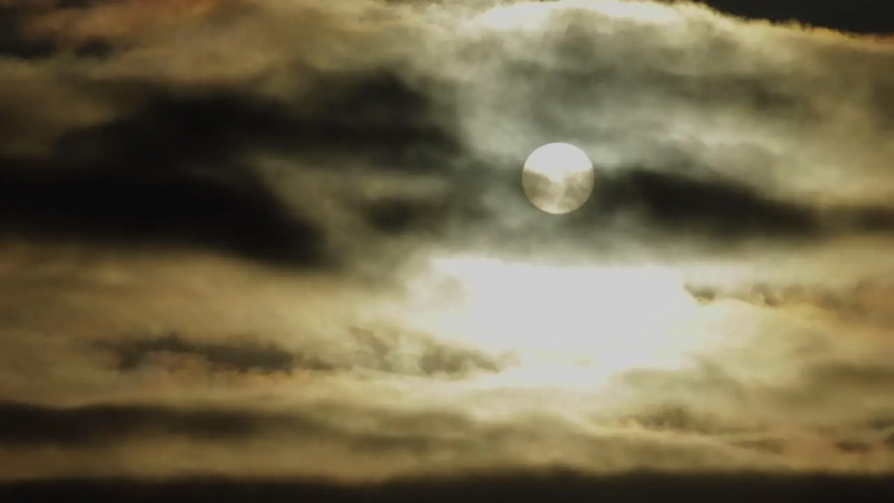 Full moon at night with moving clouds