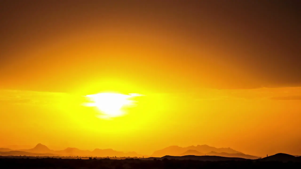 Sunrise from behind the horizon and clouds