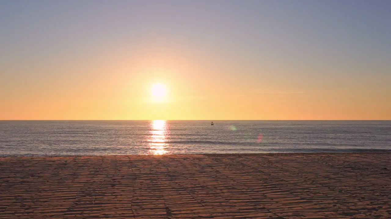 Slow Panning Shot of Golden Sun Going Down in the Sea Ocean Seascape