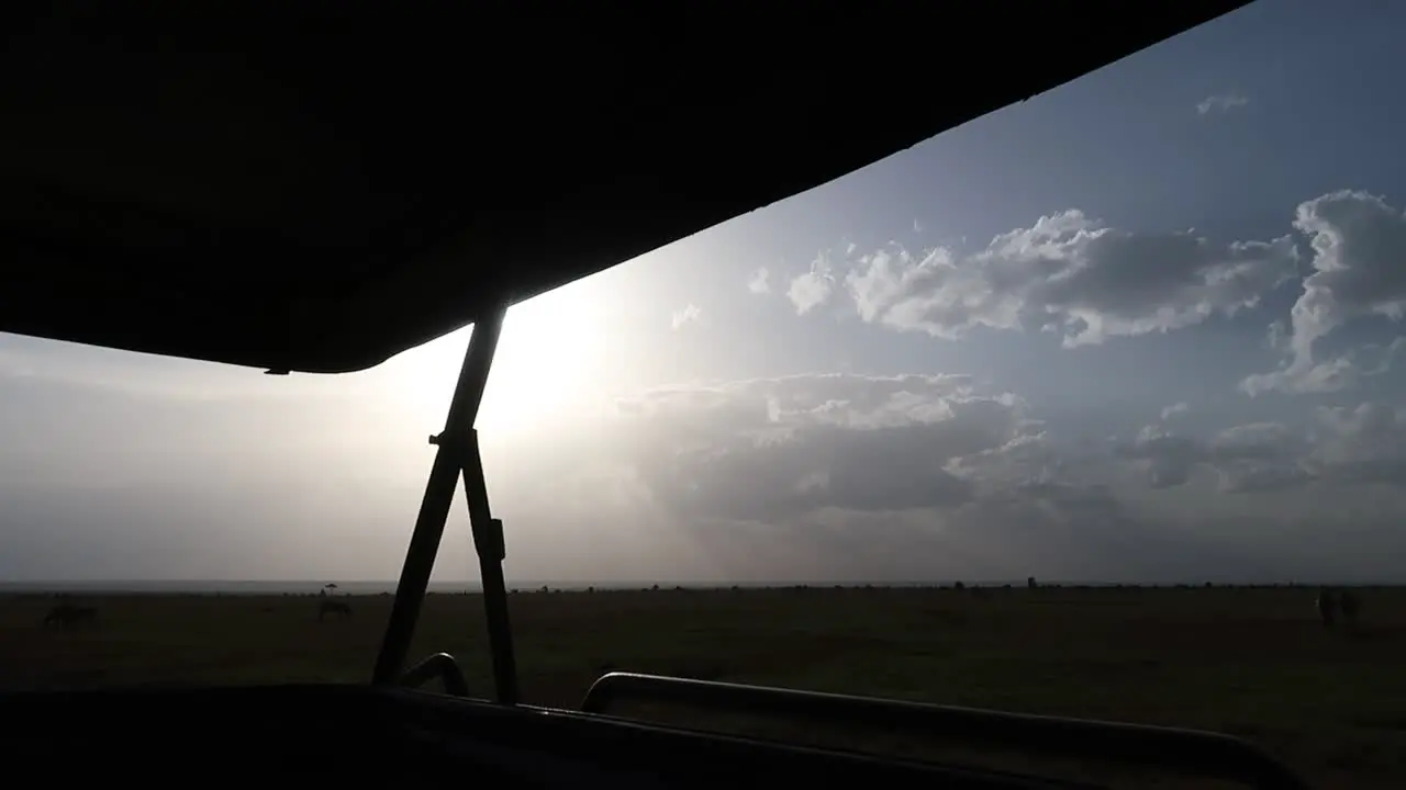 Hand-held sunset shot from inside a 4x4 safari car in the african savannah