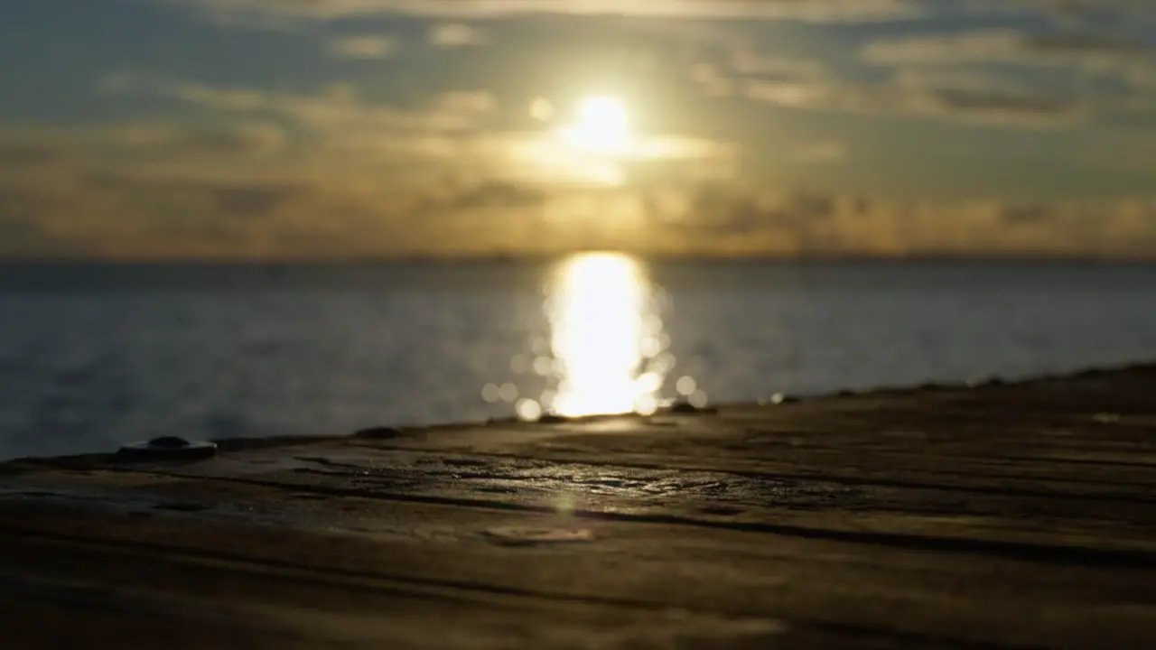 Focus shifts from a wooden pier to sun setting over the North Sea in Germany sunset over sea