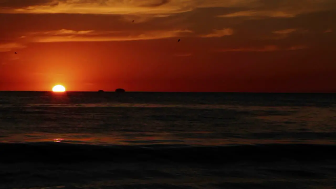 Waves breaking on beach at sunset