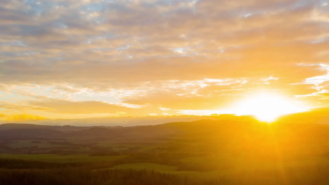 Beautiful altocumulus clouds rolling over the peaceful mountain village of Poland during sunset time lapse