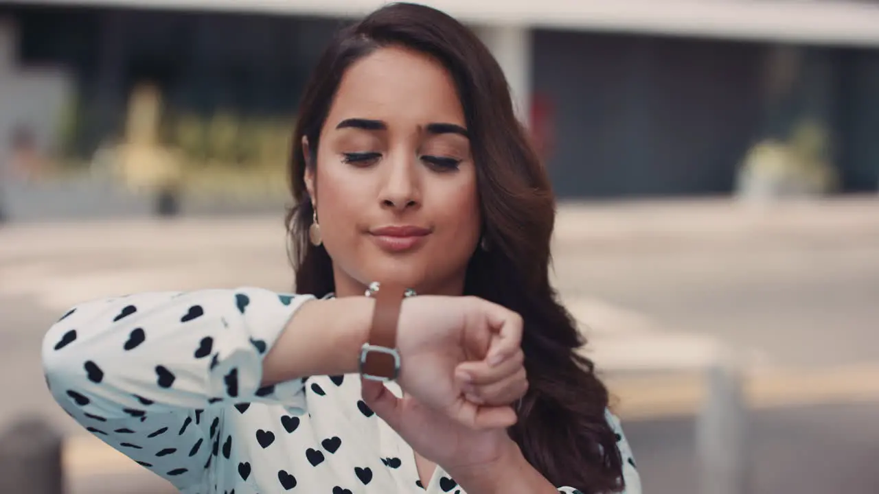 Slow Motion Portrait of beautiful Indian woman using smart watch