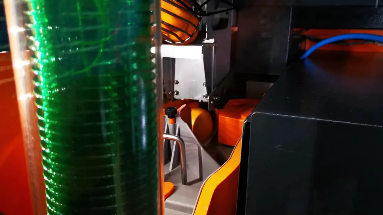 Orange juice machine oing through the process of selecting and cutting oranges