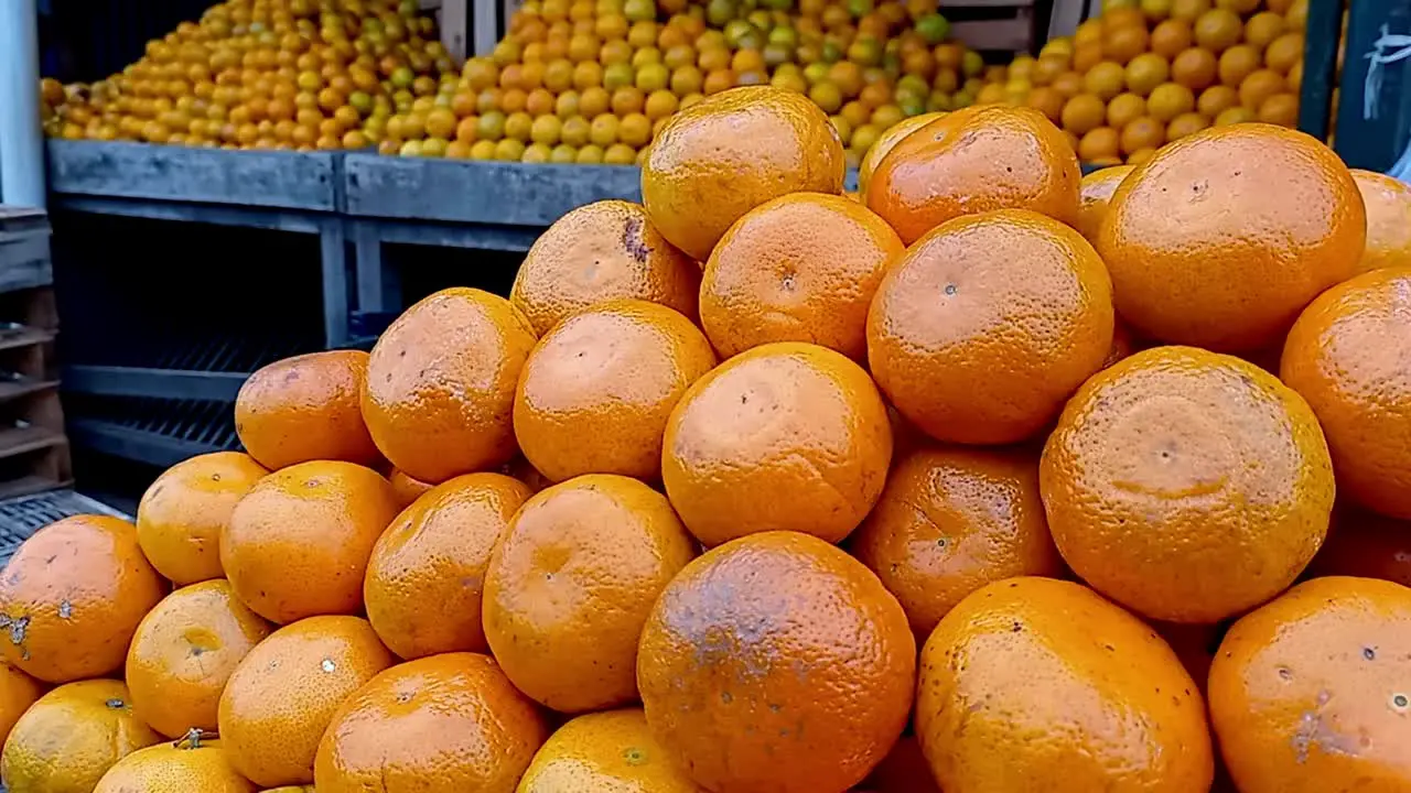 Close Up Shot Of Delicious Orange Fresh Fruits Displayed In Piles In Local Market Paraguay