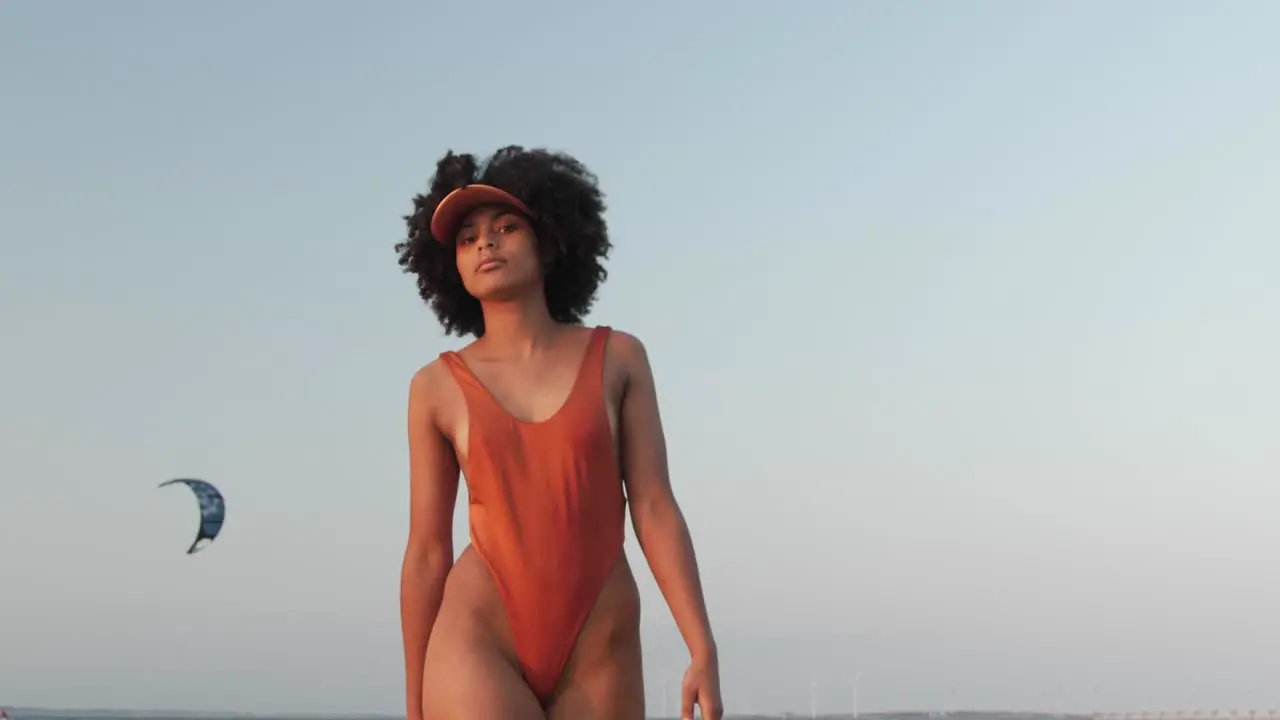 Girl with curly afro hair walking towards the camera