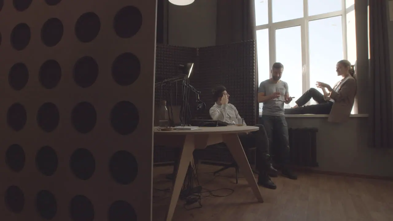 Three Stylish And Proactive Young Modern Professionals Having A Funny Conversation In A Radio Studio Before Or After Recording