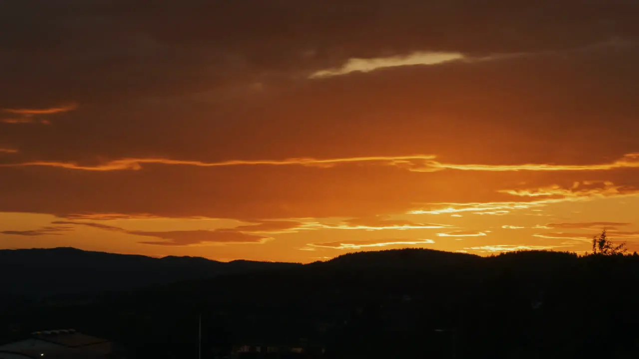 Orange clouds at sunset over Swedish mountains Timelapse