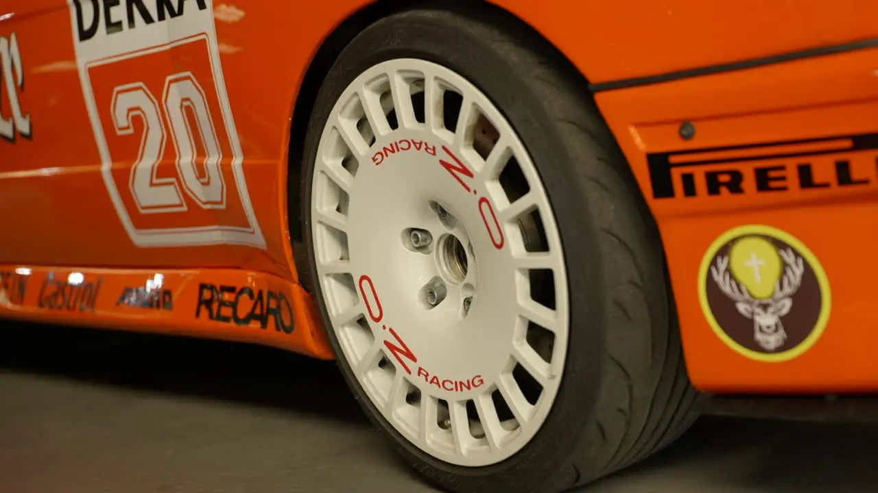 Close up of wheel or orange sport BMW e30 car vehicle during fan meeting