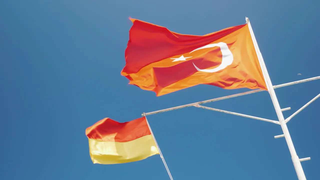 The Turkish Flag And The Flag Of The Rescue Service Are Fluttering Against The Blue Sky Safe Rest Co